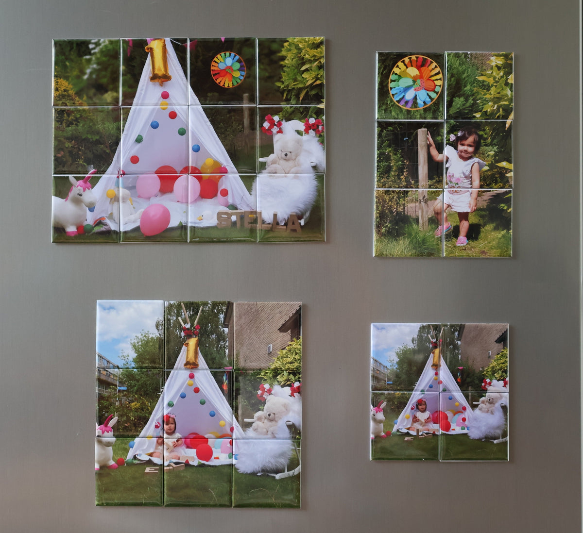 Four square custom photo wall tiles arranged in a 2x2 grid on a gray wall. Each tile is made of multiple small square mirror-like segments showing a colorful children's play scene with a teepee, toys, and a child.